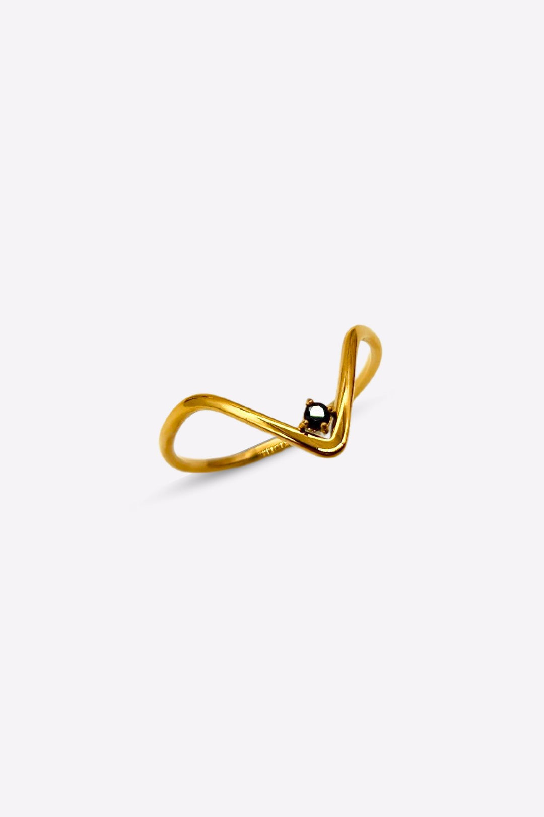 Thin v-shaped gold ring with black onyx stone at the tip. 