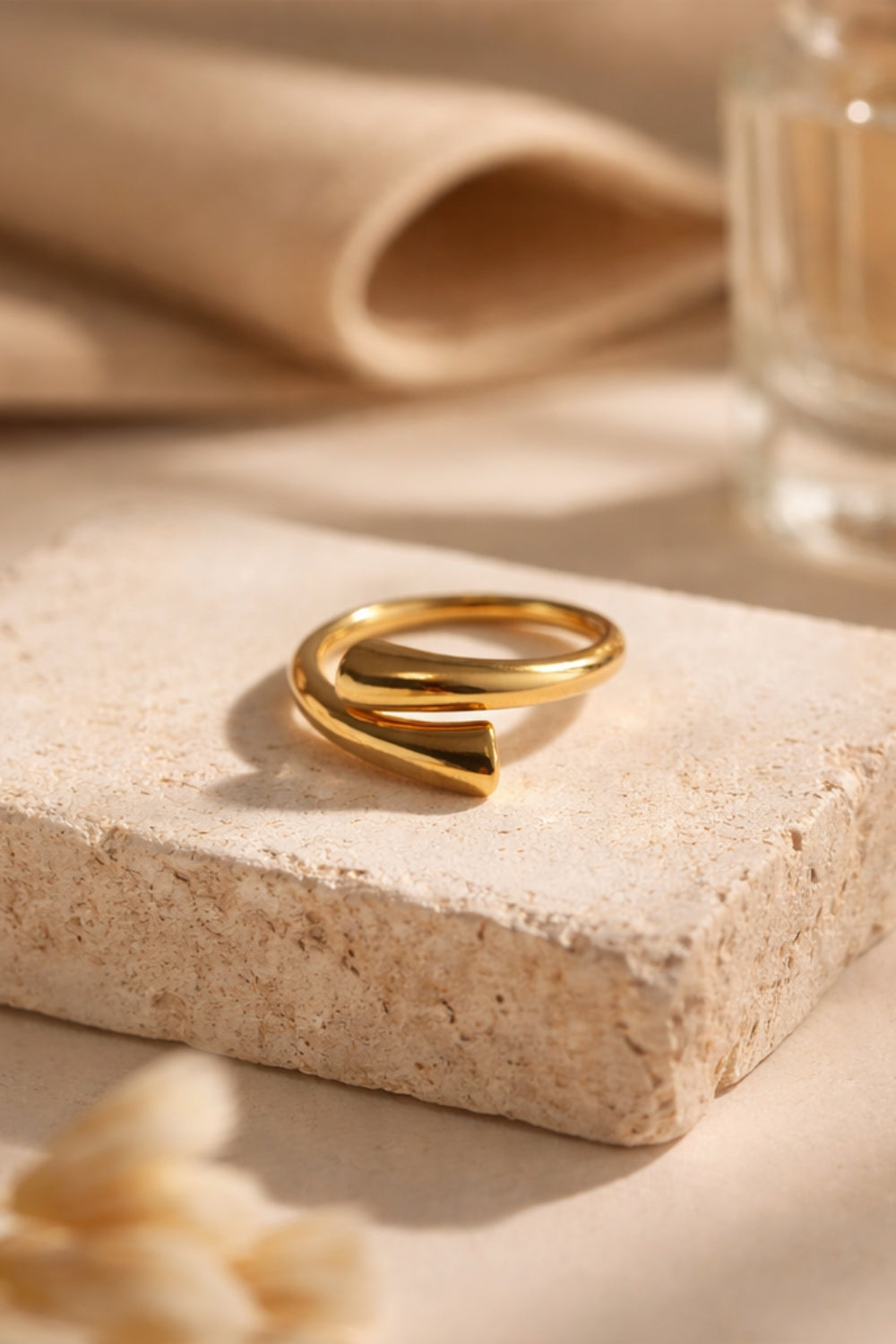 gold open cuff wrap ring 18k pvd plated stainless steel on textured stone slab warm neutral aesthetic