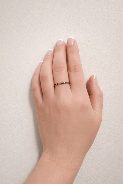 Black enamel filigree 18k PVD gold plated stainless steel band ring worn on finger minimal hand model neutral background