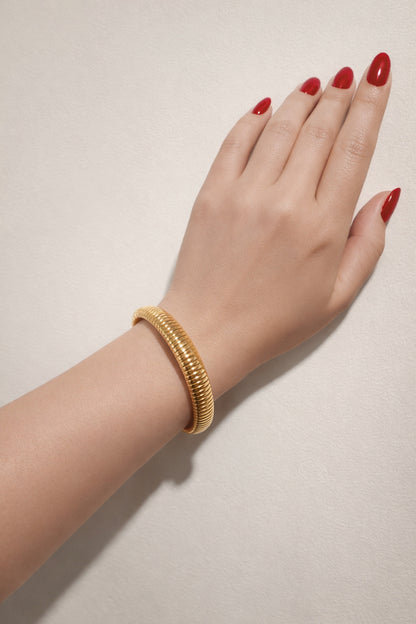 gold snake chain stainless steel bangle bracelet on wrist lifestyle view almond red nails