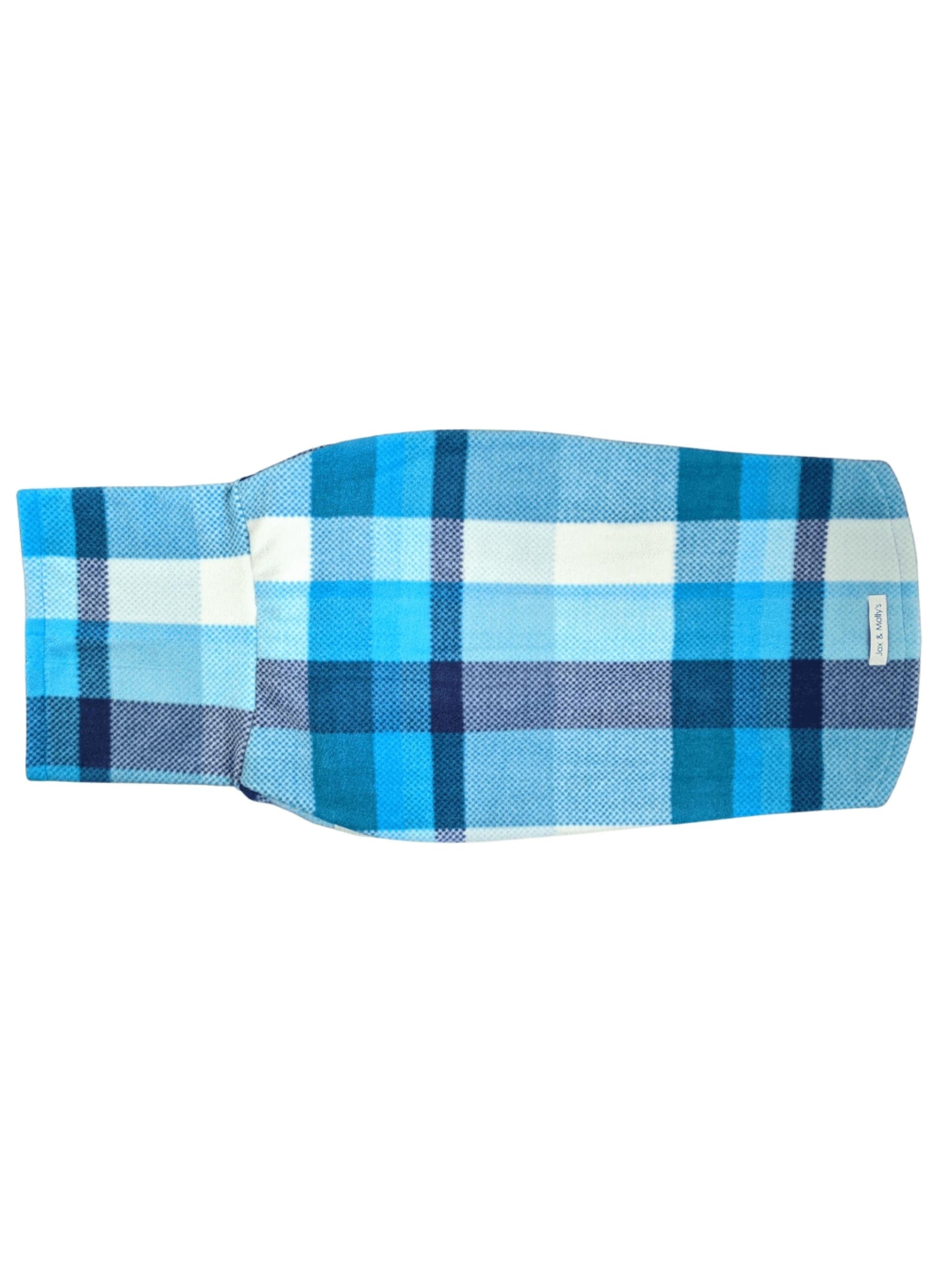 Backside view of a delightful dog sweater featuring a turtleneck, adorned with a blue plaid print and white sleeve trim.