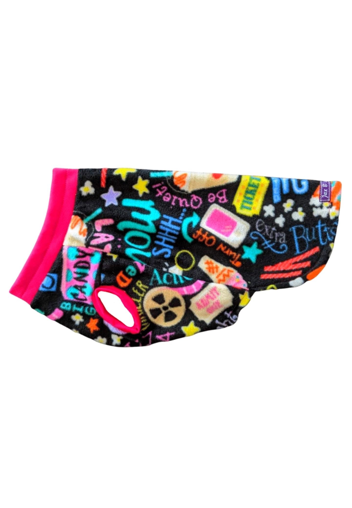 Side profile of a black dog sweater adorned with a cinematic-themed print, featuring vibrant fuchsia trim around the neck and sleeves.