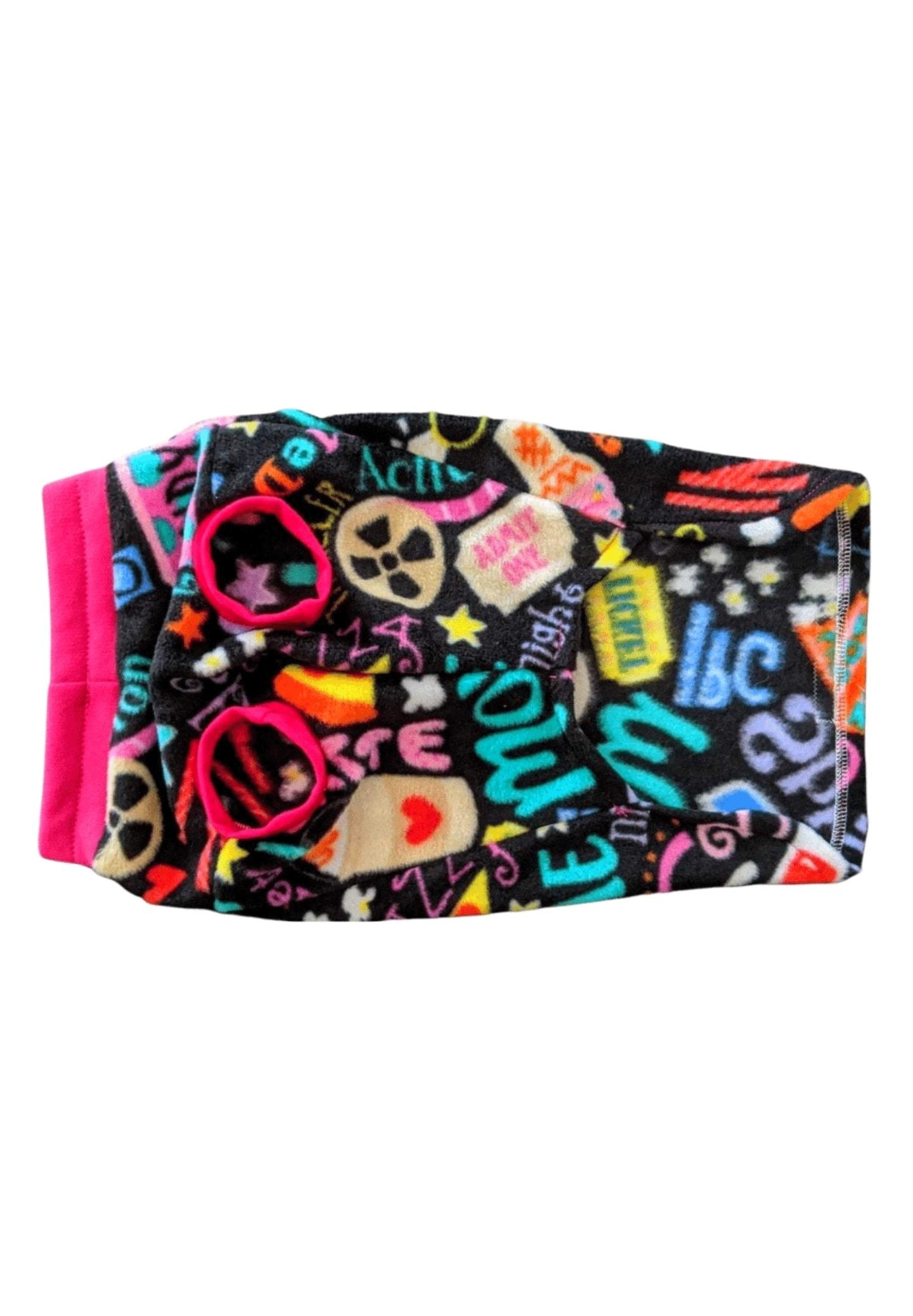 Underbelly view of a black dog sweater adorned with a cinematic-themed print, featuring vibrant fuchsia trim around the neck and sleeves.
