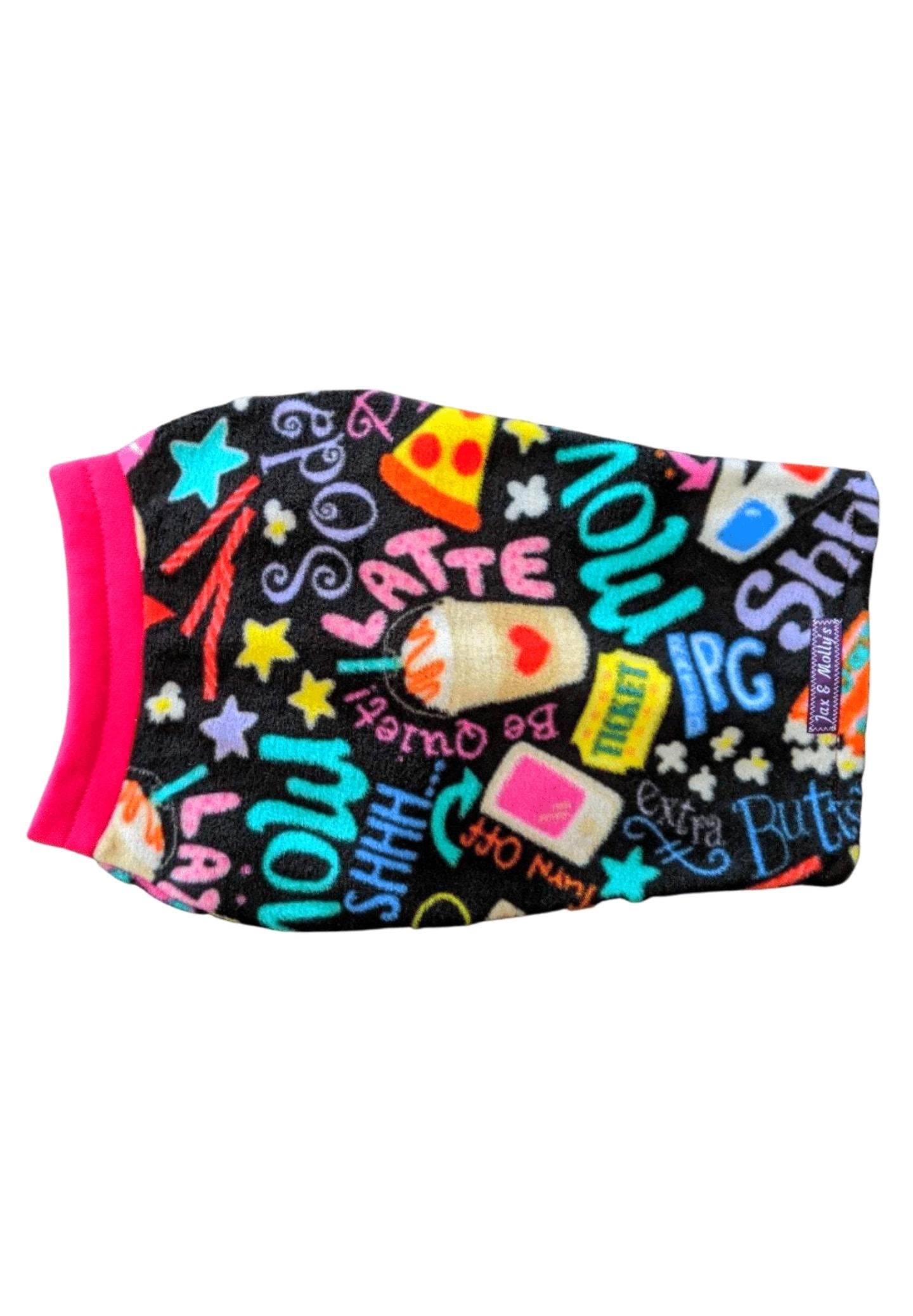 Back view of a black dog sweater adorned with a movie-themed print, highlighted by Fuchsia trim on the neck.