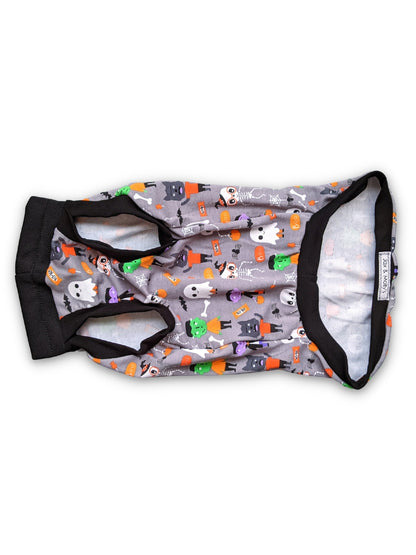 Underbelly View of the monster squad Halloween Dog Muscle Tank by Jax & Molly's, featuring a playful print of iconic monsters like Dracula and Frankensteins accented with black trim on a white background.