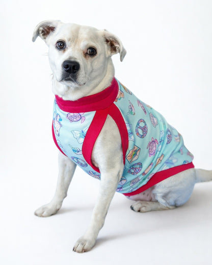 Dog wearing Peaceful Sunset dog pajamas with fuchsia trim, front view