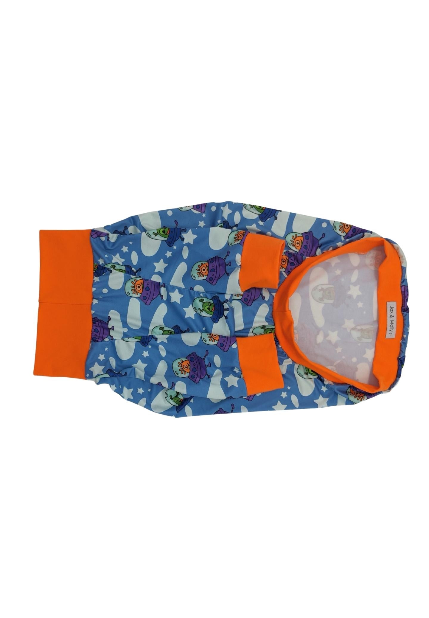 Close-up of Playful Aliens dog pajamas fabric featuring colorful aliens and UFO pattern