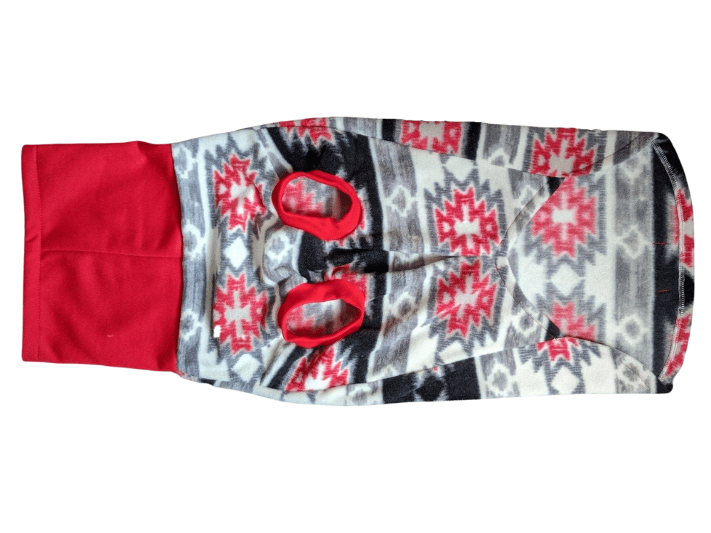 Underbelly view of Jax & Molly's striking Aztec fleece dog sweater in red, gray, white, and black colors and paired with a vibrant red sweatshirt turtleneck.