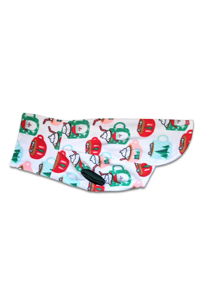 Display of a holiday dog sweater with a print of cocoa mugs adorned with Santa faces and pine trees on white background.